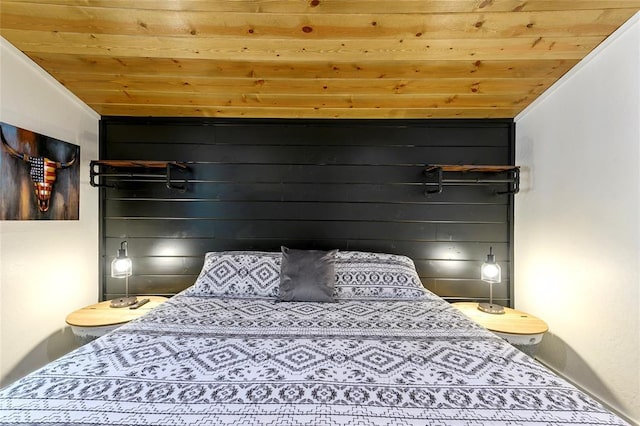 bedroom with lofted ceiling and wooden ceiling