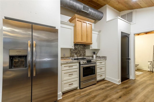 kitchen with stainless steel appliances, light stone counters, tasteful backsplash, light brown cabinetry, and wooden ceiling