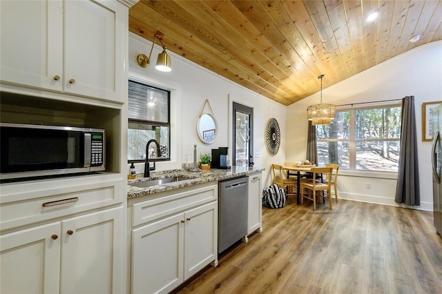 kitchen with wood ceiling, white cabinetry, light stone counters, vaulted ceiling, and appliances with stainless steel finishes