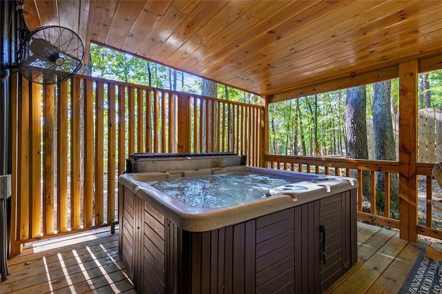 wooden deck featuring a hot tub