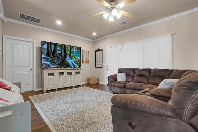 living room featuring dark wood-type flooring, ceiling fan, and ornamental molding