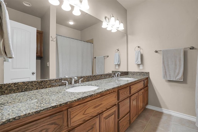 bathroom with tile patterned flooring, vanity, and walk in shower