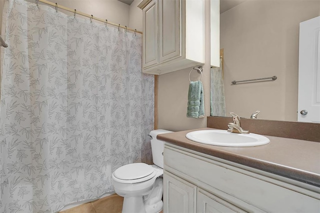 bathroom featuring vanity, tile patterned floors, and toilet