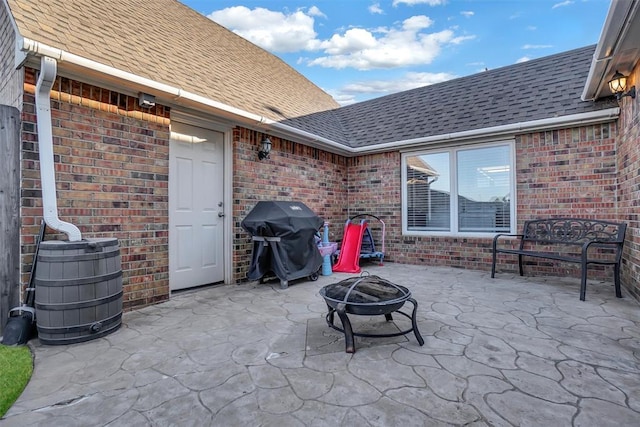 view of patio featuring a grill and an outdoor fire pit