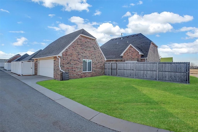 exterior space featuring a garage and a front yard