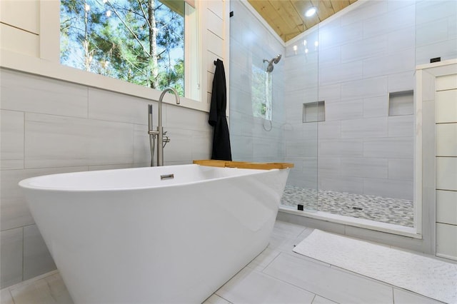 bathroom featuring tile patterned flooring, shower with separate bathtub, vaulted ceiling, and wood ceiling