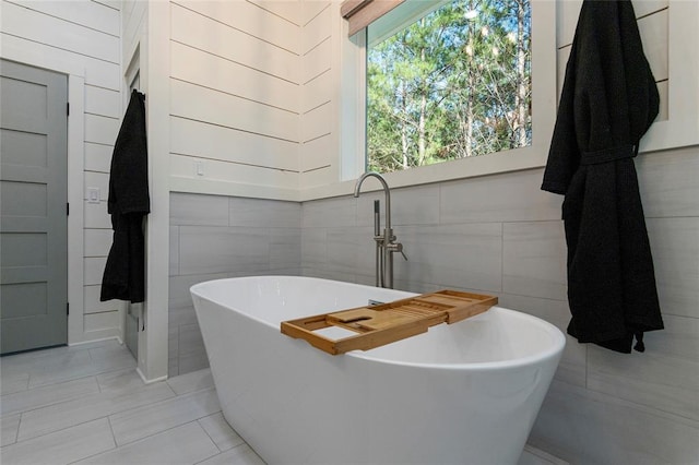 bathroom featuring tile patterned floors and a tub