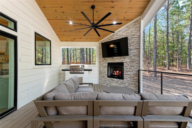 exterior space with area for grilling, an outdoor living space with a fireplace, and ceiling fan