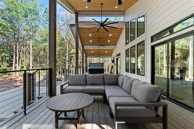 wooden terrace with ceiling fan, an outdoor hangout area, and area for grilling