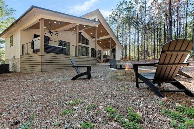 rear view of property featuring central AC unit, a fire pit, and ceiling fan