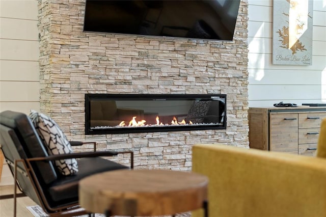 interior details with a fireplace and wood walls