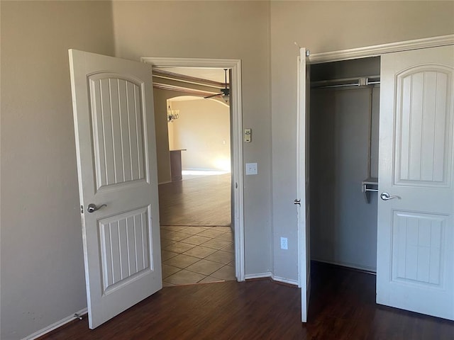 unfurnished bedroom with dark hardwood / wood-style floors and a closet