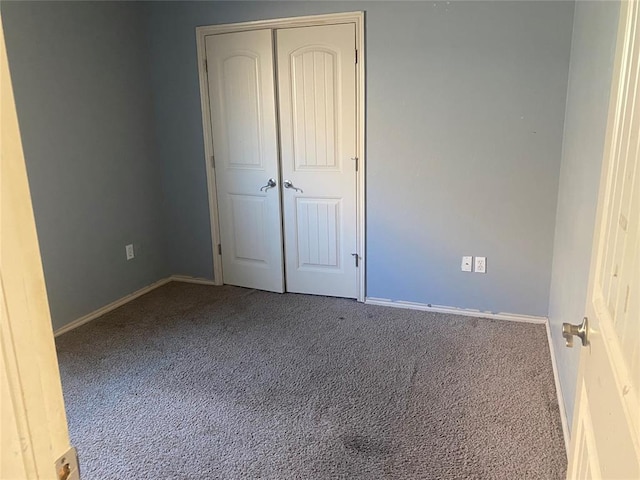 unfurnished bedroom with carpet floors and a closet