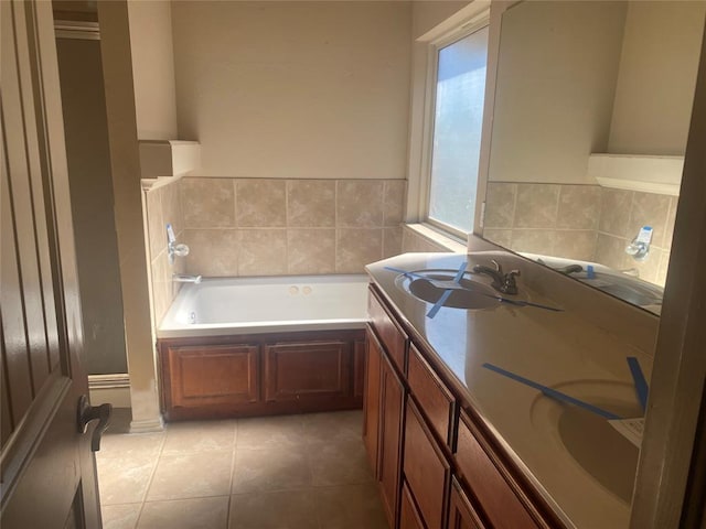 bathroom featuring a washtub, vanity, and tile patterned flooring