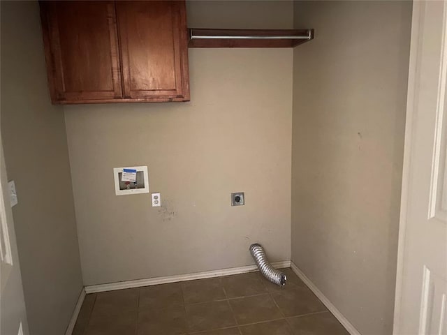 clothes washing area with hookup for a washing machine, dark tile patterned floors, hookup for an electric dryer, and cabinets