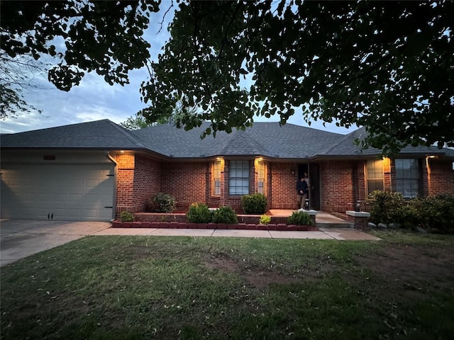 ranch-style house with a garage and a front lawn