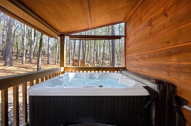 wooden deck with a hot tub