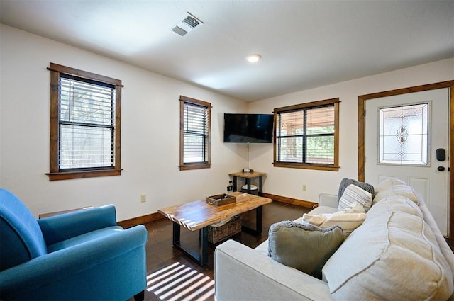 living room featuring a wealth of natural light and dark hardwood / wood-style floors