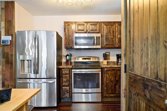 kitchen featuring dark wood-type flooring and stainless steel appliances