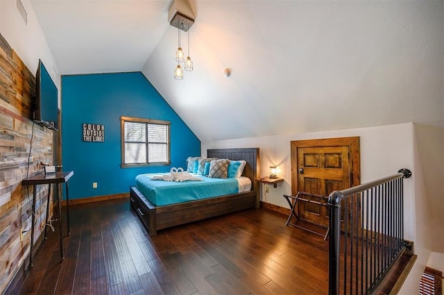 bedroom with dark hardwood / wood-style flooring and lofted ceiling