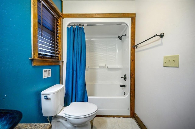 bathroom with shower / bathtub combination with curtain and toilet