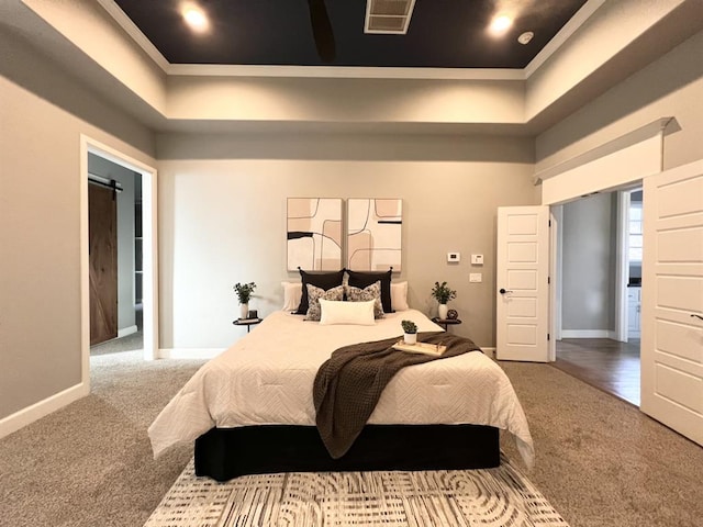 carpeted bedroom featuring crown molding and a barn door