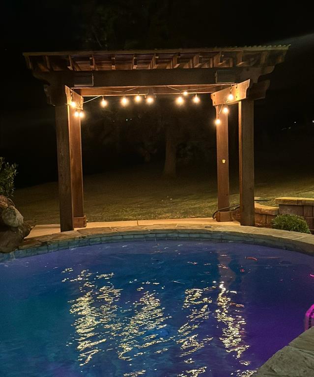 view of pool at night