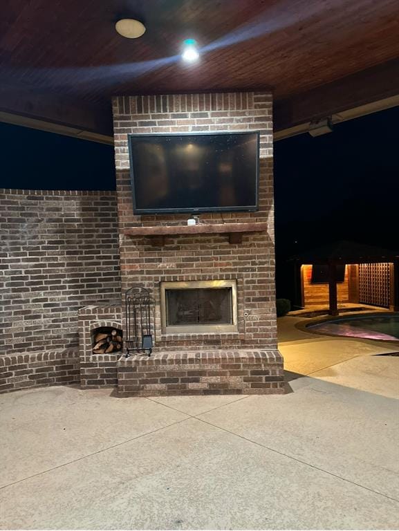 view of patio with a brick fireplace