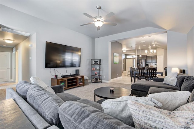 living room featuring light carpet, ceiling fan with notable chandelier, and vaulted ceiling