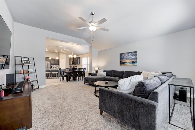 living room featuring ceiling fan with notable chandelier, light colored carpet, and vaulted ceiling