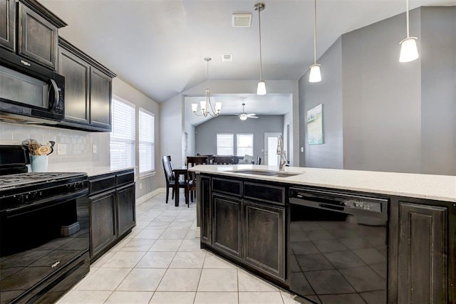 kitchen with tasteful backsplash, decorative light fixtures, vaulted ceiling, and black appliances