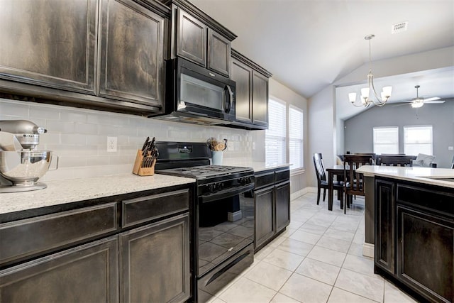 kitchen with lofted ceiling, gas stove, hanging light fixtures, a wealth of natural light, and decorative backsplash