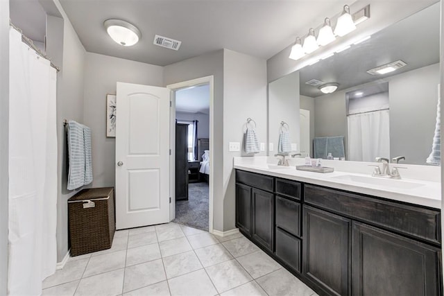 bathroom with tile patterned floors and vanity