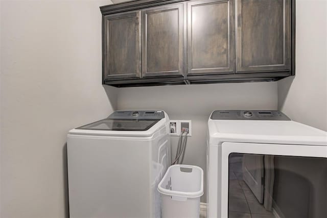 washroom featuring cabinets, separate washer and dryer, and tile patterned flooring