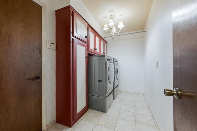 9718 Hummingbird Ln, Oklahoma City, OK 73162 - washroom featuring cabinets, washing machine and clothes dryer, a chandelier, and light tile patterned flooring