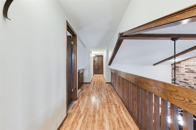 9718 Hummingbird Ln, Oklahoma City, OK 73162 - corridor with brick wall, light hardwood / wood-style floors, a textured ceiling, and vaulted ceiling with beams