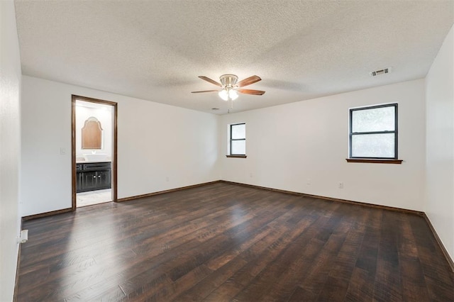9718 Hummingbird Ln, Oklahoma City, OK 73162 - unfurnished room with ceiling fan, dark hardwood / wood-style flooring, and a textured ceiling