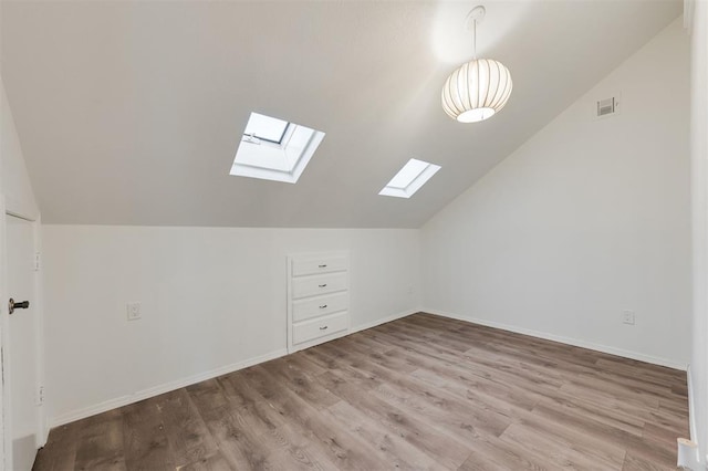 9718 Hummingbird Ln, Oklahoma City, OK 73162 - bonus room featuring vaulted ceiling and light hardwood / wood-style floors