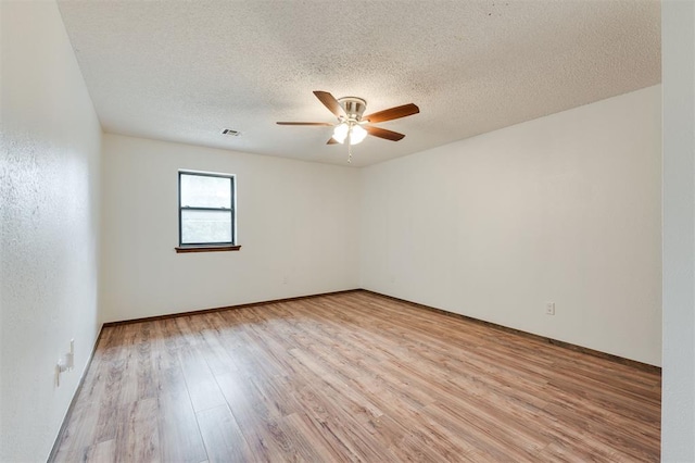 9718 Hummingbird Ln, Oklahoma City, OK 73162 - spare room with ceiling fan, light hardwood / wood-style floors, and a textured ceiling