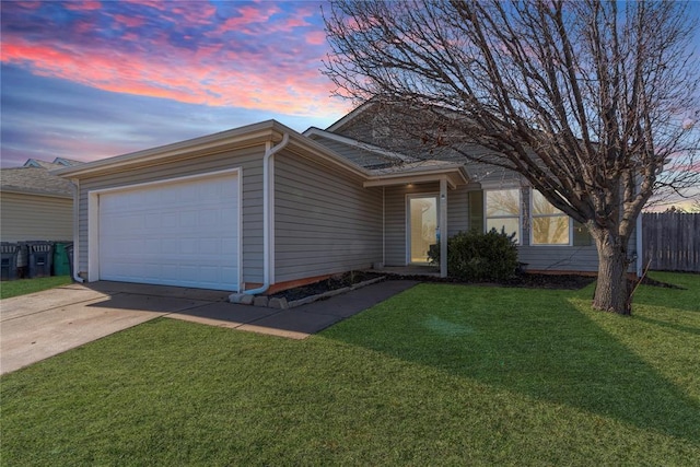 single story home featuring a garage and a yard