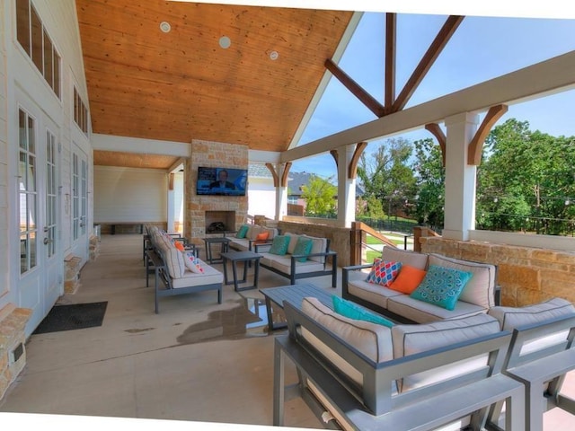 view of patio / terrace with french doors and an outdoor living space with a fireplace