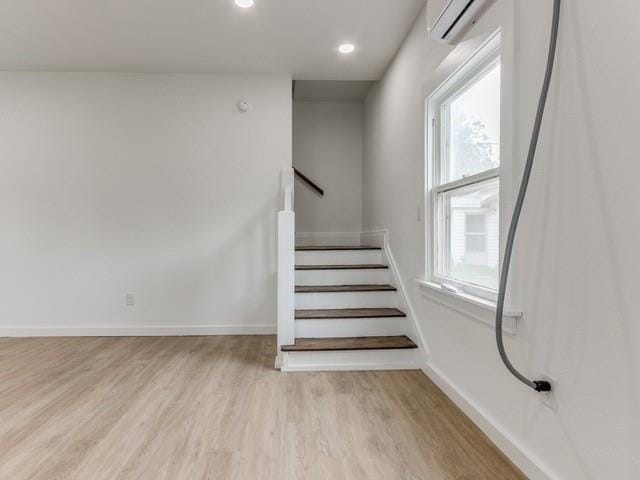 stairway with hardwood / wood-style floors