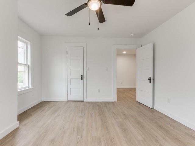 unfurnished room with light hardwood / wood-style flooring and ceiling fan