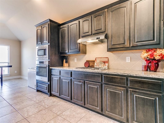 kitchen with decorative backsplash, stainless steel appliances, dark brown cabinets, and light tile patterned floors