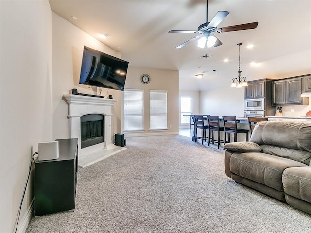 living room featuring light carpet and ceiling fan