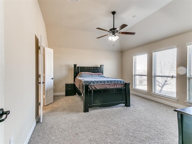 carpeted bedroom featuring lofted ceiling and ceiling fan