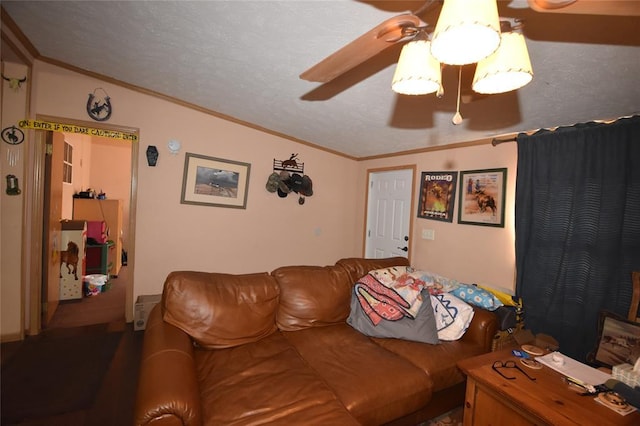 living room featuring ornamental molding, vaulted ceiling, a textured ceiling, and ceiling fan