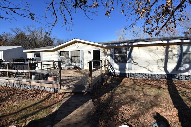 rear view of house featuring a deck