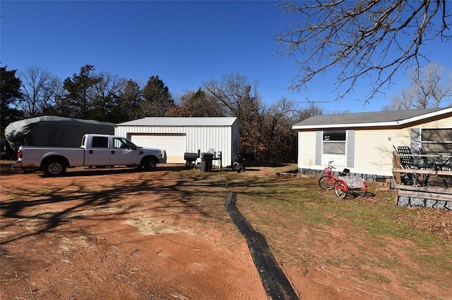 view of home's exterior with a garage and an outdoor structure