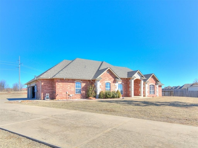 ranch-style home with a garage and a front yard